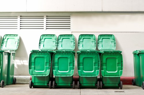 Protective equipment and labelled bins during rubbish collection